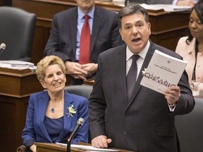 Ontario's Premier Kathleen Wynne (centre) sits next to Provincial Finance Minister Charles Sousa (right) as the Ontario Provincial Government delivers its 2018 Budget , at the Queens Park Legislature in Toronto, on Wednesday March 28, 2018.