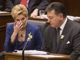 Ontario's Premier Kathleen Wynne (left) sits with Provincial Finance Minister Charles Sousa after the Ontario Provincial Government delivered its 2018 Budget , at the Queens Park Legislature in Toronto, on Wednesday March 28, 2018.