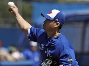 Toronto Blue Jays relief pitcher Seung-Hwan Oh delivers to the Philadelphia Phillies during the fifth inning of a spring training baseball game Wednesday, March 21, 2018, in Dunedin, Fla. (AP Photo/Chris O'Meara)