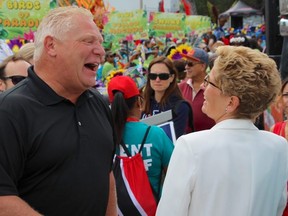 Doug Ford and Kathleen Wynne joke at the Junior Carnival in Toronto on July 16, 2016. (Nick Westoll/Toronto Sun/Postmedia Network)