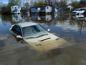 Flood waters breach the Gatineau River and flood the neighbourhood in Gatineau, Quebec on Wednesday, May 10, 2017. THE CANADIAN PRESS/Sean Kilpatrick