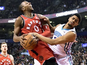 Toronto Raptors forward C.J. Miles (0) collides with Charlotte Hornets guard Jeremy Lamb on his way to the basket Sunday, March 4, 2018, in Toronto. (Frank Gunn/The Canadian Press via AP)