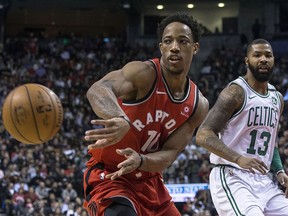 Toronto Raptors DeMar DeRozan (left) passes off in front of Boston Celtics Marcus Morris in Toronto on Tuesday, February 6, 2018. (THE CANADIAN PRESS/Chris Young)