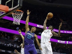 Toronto Raptors forward Pascal Siakam, of Cameroon, pulls in a rebound against Charlotte Hornets center Dwight Howard in the first half of an NBA basketball game in Charlotte, N.C., on Sunday, Feb. 11, 2018. Toronto won 123-103.