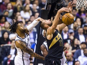 Toronto Raptors' Jonas Valanciunas is fouled by Brooklyn Nets defender D'Angelo Russell at the Air Canada Centre in Toronto, Ont. on Friday March 23, 2018. (Ernest Doroszuk/Toronto Sun)
