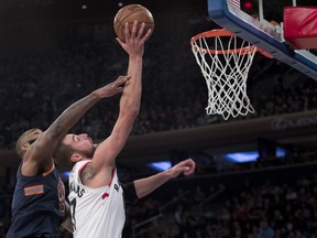 Toronto Raptors centre Jonas Valanciunas, front right, goes to the basket past New York Knicks center Kyle O'Quinn, left, during the first half of an NBA basketball game, Sunday, March 11, 2018, at Madison Square Garden in New York. (AP Photo/Mary Altaffer)