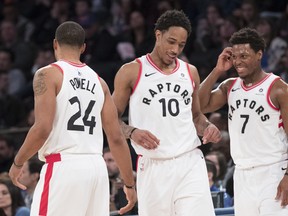 Toronto Raptors guard DeMar DeRozan (10), forward Norman Powell (24) and guard Kyle Lowry (7) react during the final minutes of the second half of an NBA basketball game, Sunday, March 11, 2018, at Madison Square Garden in New York. The Raptors won 132-106. AP