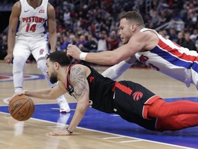 Detroit Pistons forward Blake Griffin, top, and Toronto Raptors guard Fred VanVleet chase the ball during the second half of an NBA basketball game, Wednesday, March 7, 2018, in Detroit. AP