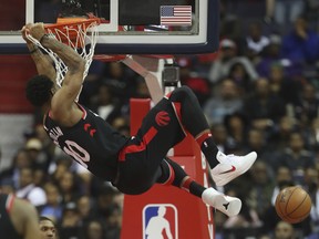 Toronto Raptors guard DeMar DeRozan (10) hangs ofrom the rim after a dunk against the Washington Wizards during the second half of an NBA basketball game Friday, March 2, 2018, in Washington. Toronto won 102-95. The Associated Press