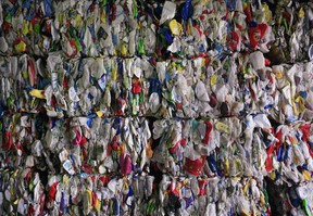 Recyclable materials compressed into large cubes are stacked at the Dufferin Waste Management facility in Toronto on Thursday, March 12, 2009.