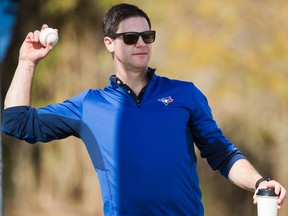 Toronto Blue Jays general manager Ross Atkins throws a ball during baseball spring training in Dunedin, Fla., on Feb. 19, 2017