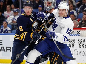 Buffalo Sabres defenceman Casey Nelson and Toronto Maple Leafs forward Patrick Marleau battle for position during an NHL game on March 15, 2018