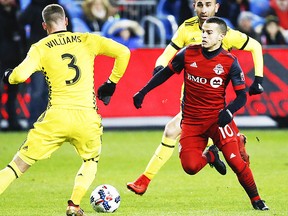 Toronto FC's Sebastian Giovinco F (10) tries to push past Columbus Crew defender Josh Williams during the first half MLS playoff action in Toronto, Ont. on Wednesday November 29, 2017. Jack Boland/Toronto Sun/Postmedia Network