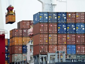 A container is loaded onto a cargo ship at the Tianjin port in China on Aug. 5, 2010.