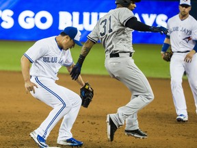 Blue Jays’ Seung-hwan Oh is late getting to first base as the Yankees’ Aaron Hicks is called safe at the Rogers Centre on Thursday. 
(Ernest Doroszuk/Toronto Sun/Postmedia Network