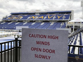 A sign warns of high winds as workers finish work on Navy–Marine Corps Memorial Stadium, Friday, March 2, 2018, in Annapolis, Md. (AP Photo/Stephen Whyno)