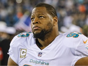 This Nov. 13, 2017, file photo shows Miami Dolphins' Ndamukong Suh (93) on the sidelines before a game against the Carolina Panthers in Charlotte, N.C.  (AP Photo/Bob Leverone, File)