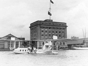 In May, 1921, the flying boat, Santa Maria, operated by Aeromarine Airways Inc., paid a visit to Toronto, where the aircrew were hosted by the Aero Club of Canada. The aircraft (a war surplus Curtiss F-5L3, ex-Royal Air Force Felixstowe F.5Ls) is seen “moored” in front of the not-yet three-year-old Toronto Harbour Commission administration building was on a goodwill trip from Havana, Cuba to Detroit via Washington, New York City, Montreal and Toronto. The Aeromarine company also had the contract to carry mail between U.S. and Cuban ports. In this view wooden warehouses occupy the narrow parcels of land on either side of the Harbour Commission building. (Port Authority Archives)