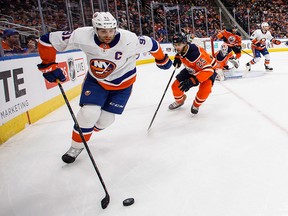 New York Islanders' John Tavares is chased by Edmonton Oilers' Darnell Nurse  during first period NHL action in Edmonton, on Thursday March 8, 2018. THE CANADIAN PRESS/Jason Franson