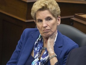 Premier Kathleen Wynne listens to her throne speech being delivered by The Lieutenant Governor of Ontario, The Honourable V. Elizabeth Dowdeswell at Queens Park in Toronto, Ont. on Monday, March 19, 2018.. Stan Behal/Toronto Sun/Postmedia Network