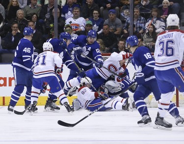 Toronto Maple Leafs Curtis McElhinney G (35) is crushed under and avalanche of Montreal Canadiens during the first period in Toronto on Saturday March 17, 2018. Jack Boland/Toronto Sun/Postmedia Network