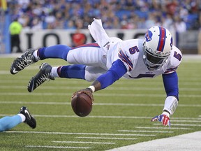 In this Aug. 15, 2015 file photo, Buffalo Bills quarterback Tyrod Taylor (5) dives for the first down marker against the Carolina Panthers in Orchard Park, N.Y. (AP Photo/Bill Wippert, File)