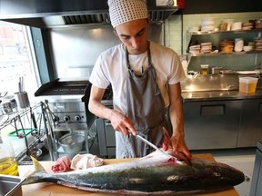 Dylan Vickers, a chef at Skippa on Harbord St., prepares a yellow tail fish for the evening's dinner crowd at Skippa sushi restaurant on Harbord St. He lost his personal sushi knives he has collected over the past decade after he exited an Uber ride. The company said they had them at their Mississauga lost and found, but then when he went to get them back again they he said they'd been disposed of because they were dangerous. on Thursday March 8, 2018. Jack Boland/Toronto Sun/Postmedia Network