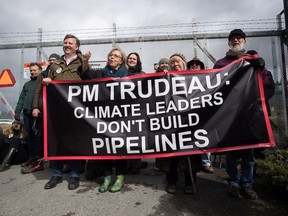 Federal Green Party Leader Elizabeth May, centre left, and NDP MP Kennedy Stewart, left, stand with protesters before they were arrested outside Kinder Morgan's facility in Burnaby, B.C., on Friday March 23, 2018.