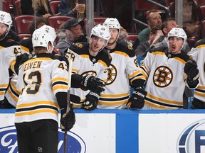 Teammates congratulate Boston's Danton Heinen after he scored a goal to tie the game against the Florida Panthers on Thursday. (GETTY IMAGES)