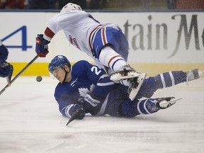 Leafs winger Kasperi Kapanen collides with Montreal Canadiens' defenceman Noah Juulsen during Saturday night's game. (STAN BEHAL/Toronto Sun)