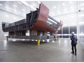 Kevin McCoy, president of Irving Shipbuilding, leads a tour as workers construct components of the Arctic offshore patrol ships at their facility in Halifax on Friday, March 4, 2016. The federal government is scrambling to close a looming gap in the construction of two new fleets of naval vessels in Halifax, which Irving Shipbuilding has previously warned could result in layoffs if left unaddressed.