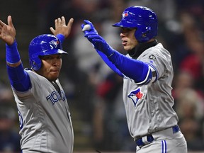 Toronto Blue Jays' Aledmys Diaz, right, is congratulated by Yangervis Solarte after hitting a three-run home run off Cleveland Indians starting pitcher Mike Clevnger on Friday. AP PHOTO