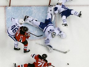 New Jersey Devils right winger Kyle Palmieri shoots as Toronto Maple Leafs goaltender Frederik Andersen dives to make the save during NHL action on April 5, 2018