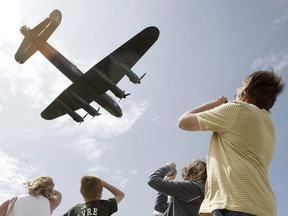 Spectators watch an operational Avro Lancaster fly near Winnipeg's James Richardson International Airport in August, 2009.
(Toronto Sun files)