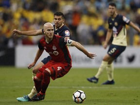 Toronto FC's Michael Bradley dribbles past Club America's Emanuel Aguilera during their match earlier this month. (THE CANADIAN PRESS)