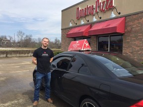 Donatos Pizza driver Ralph Letner stands outside the Somerset, Ky. location after saving 2 people from a house fire.