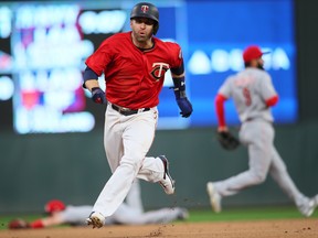 Minnesota Twins' Brian Dozier rounds second base on his way to score against the Cincinnati Reds last week. (GETTY IMAGES)