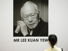 A lady pays tribute at Tanjong Pagar Community Club following the passing of former Prime Minister Lee Kuan Yew  on March 23, 2015 in Singapore.