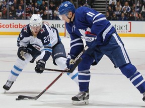 Patrik Laine #29 of the Winnipeg Jets skates to check Zach Hyman #11 of the Toronto Maple Leafs during an NHL game at the Air Canada Centre on March 31, 2018 in Toronto, Ontario, Canada. The Jets defeated the Maple Leafs 3-1.
