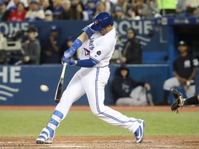 TORONTO, ON - APRIL 1: Justin Smoak #14 of the Toronto Blue Jays hits a two-run home run in the seventh inning during MLB game action against the New York Yankees at Rogers Centre on April 1, 2018 in Toronto, Canada. (Photo by Tom Szczerbowski/Getty Images)