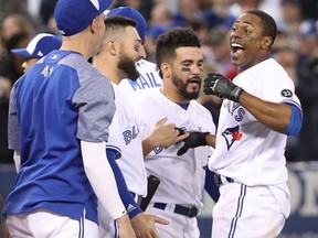 Curtis Granderson #18 of the Toronto Blue Jays is congratulated by teammates after hitting a game-winning solo home run in the tenth inning during MLB game action against the Boston Red Sox at Rogers Centre on April 24, 2018 in Toronto, Canada. (Photo by Tom Szczerbowski/Getty Images)