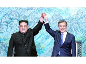 North Korean leader Kim Jong Un (L) and South Korean President Moon Jae-in (R) pose for photographs after signing the Panmunjom Declaration for Peace, Prosperity and Unification of the Korean Peninsula during the Inter-Korean Summit at the Peace House on April 27, 2018 in Panmunjom, South Korea.