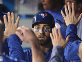 Kevin Pillar #11 of the Toronto Blue Jays is congratulated by teammates in the dugout after hitting a solo home run in the fifth inning during MLB game action against the Texas Rangers at Rogers Centre on April 28, 2018 in Toronto, Canada.
