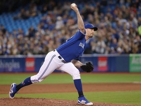 John Axford #77 of the Toronto Blue Jays delivers a pitch in the eighth inning during MLB game action against the Texas Rangers at Rogers Centre on April 28, 2018 in Toronto, Canada.