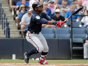 In this Friday, March 2, 2018, file photo, Atlanta Braves' Ronald Acuna watches after hitting a home run during a spring exhibition game against the New York Yankees, in Tampa, Fla. (AP Photo/Lynne Sladky, File)