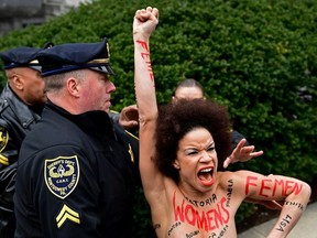 Actress Nicolle Rochelle, who appeared on several episodes of "The Cosby Show," is detained as Bill Cosby arrives for his sexual assault trial at the Montgomery County Courthouse, Monday, April 9, 2018, in Norristown, Pa.