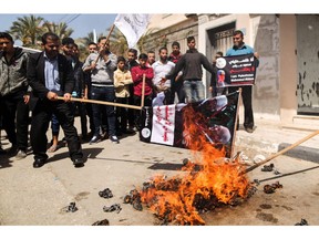 Palestinians burn a dummy representing Palestinian President Mahmud Abbas during a protest in Gaza City on March 21, 2018 against his statement in which he accused Hamas of carrying out a bomb attack against prime minister Rami Hamdallah in Gaza last week, as well as threatening fresh sanctions against them. (MAHMUD HAMS/AFP/Getty Images)