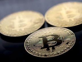 (FILES) In this file photo taken on November 20, 2017 gold plated souvenir Bitcoin coins are arranged for a photograph in London.  Bitcoin, a type of cryptocurrency, uses peer-to-peer Wild fluctuations within the bitcoin market have once again sparked debate between investors who believe it is merely undergoing a "correction" and those who see it as a costly fad. After a buying fever at the end of 2017 that sent the price of a token to nearly $20,000 and a spectacular fall at the beginning of the year, bitcoin's price made a modest recovery before falling sharply again in March 2018.