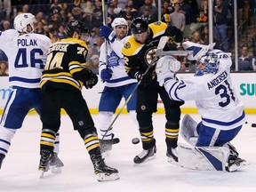 Bruins players swarm around the Maple Leafs net during Game 5 in Boston on Saturday night.
(The Associated Press)