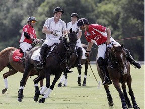 Prince Harry, centre left, and Prince William, centre right, play in a charity polo match at Coworth Park, near Ascot. The country house hotel is a favourite among the horsey set. JANE MINGAY/GETTY IMAGES